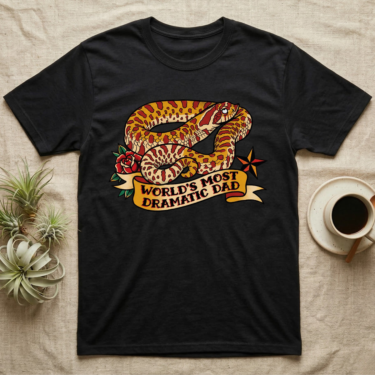 Dramatic Dad Hognose T-Shirt in Black — Tattoo-flash illustration of a hognose snake mid-dramatic-flop with a banner reading World's Most Dramatic Dad.