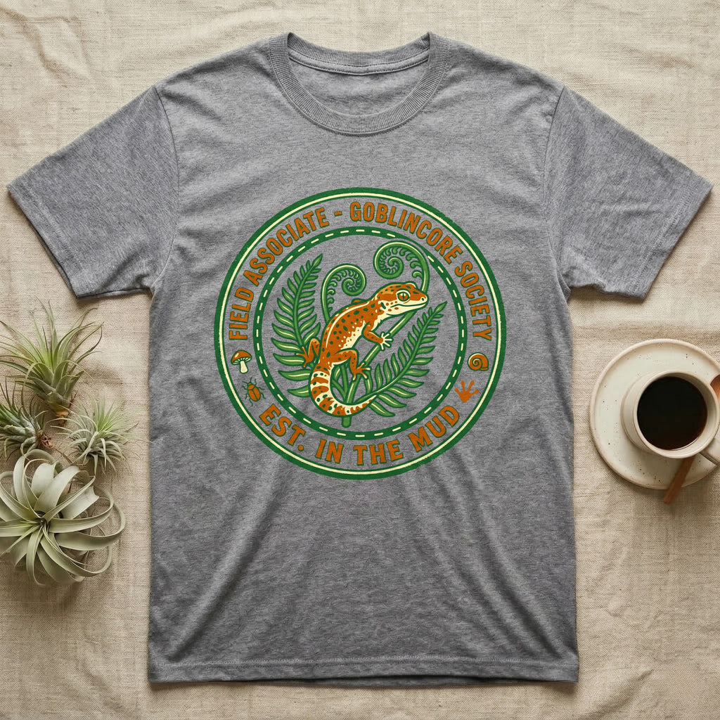 Grey t-shirt featuring a circular emblem with a gecko and foliage.