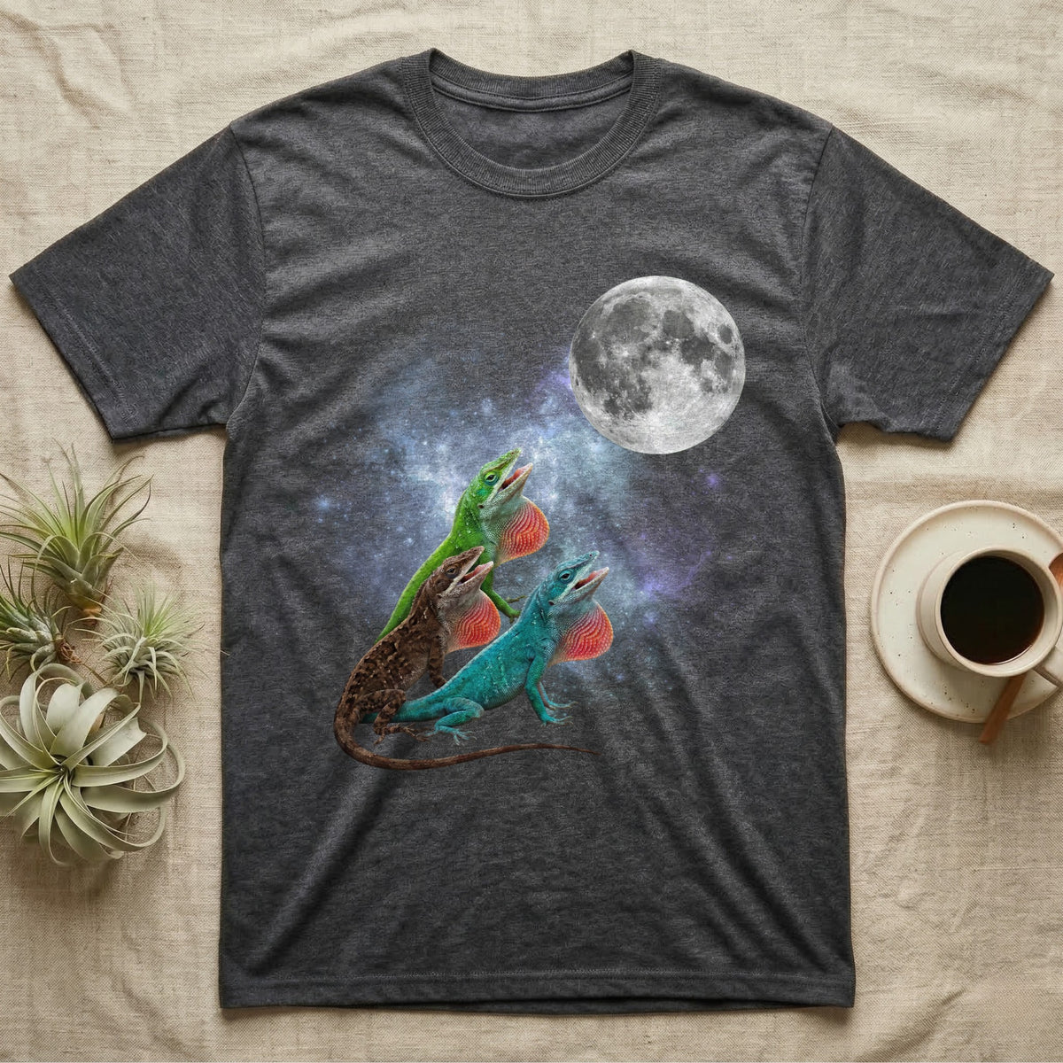 Green Anole Moon Howl T-Shirt in Dark Heather — Three Green Anole colour morphs howling at a full moon over a nebula on a dark grey t-shirt.