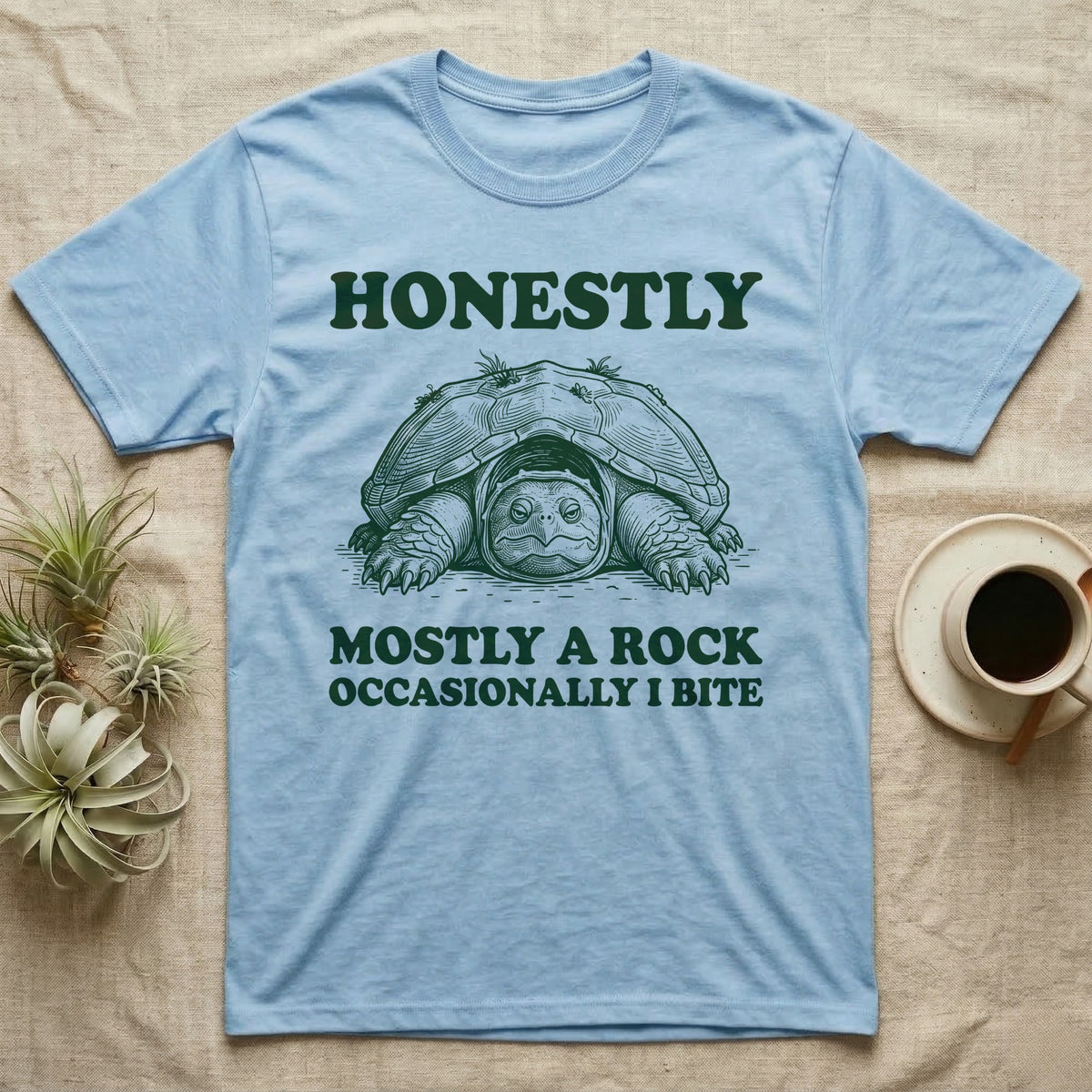 Snapping Turtle Rock T-Shirt in Light Blue — Engraved snapping turtle hunkered like a mossy rock, facing forward, with the words Honestly, Mostly a Rock, Occasionally I Bite