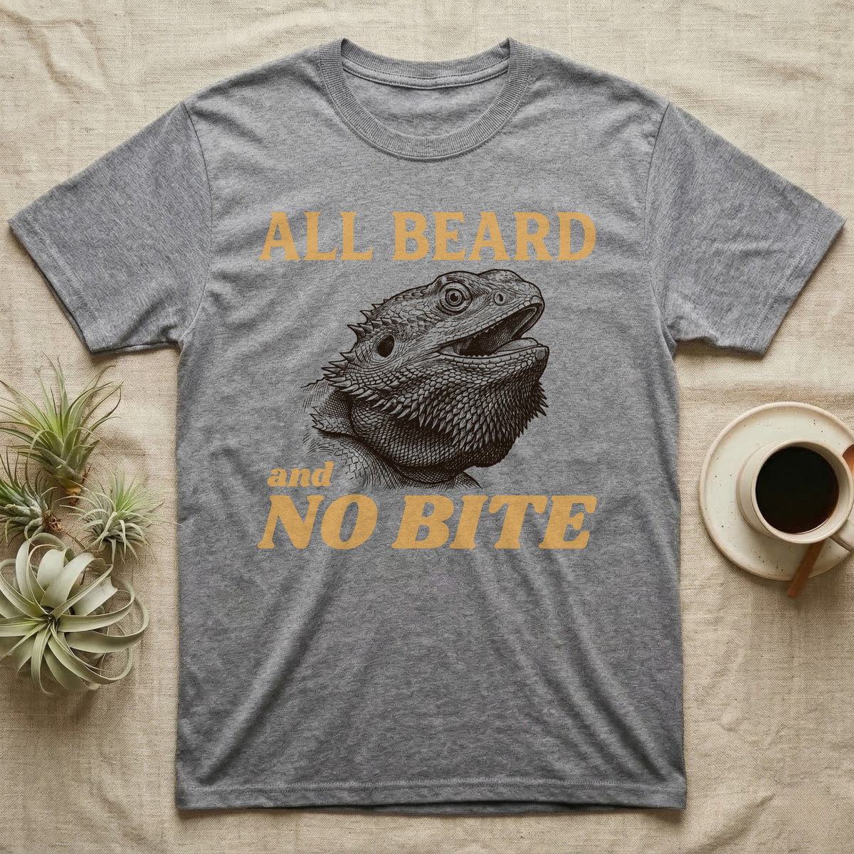 Bearded Dragon Bluff T-Shirt in Sport Grey — Engraved bearded dragon with a puffed dark beard and open mouth under sand lettering reading ALL BEARD and NO BITE