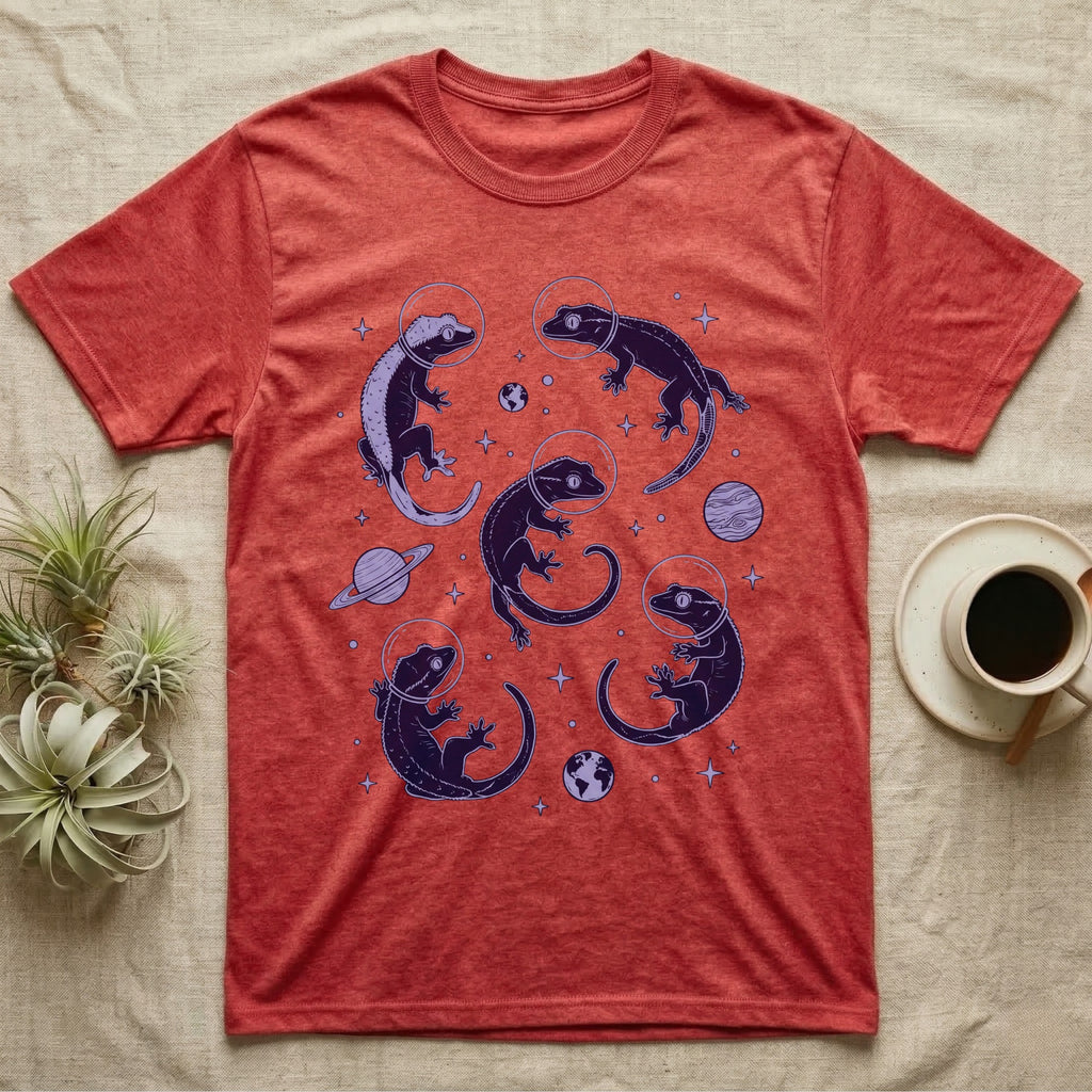Crested Gecko Cosmic T-Shirt in Heather Red — Vintage screen-print illustration of crested geckos in astronaut helmets floating in space, deep cosmic indigo monochromatic on dark background.