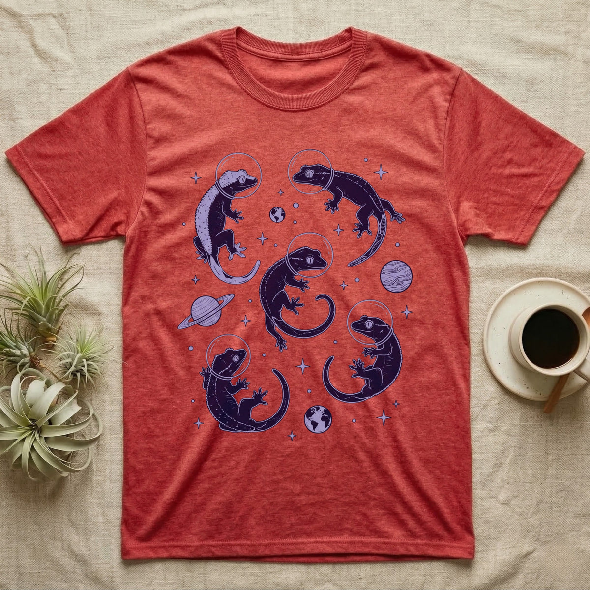 Crested Gecko Cosmic T-Shirt in Heather Red — Vintage screen-print illustration of crested geckos in astronaut helmets floating in space, deep cosmic indigo monochromatic on dark background.