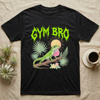 Green Anole Feral T-Shirt in Black — Green anole mid push-up with flared pink dewlap under a jagged neon-lime metal "GYM BRO" wordmark and pastel ferns.