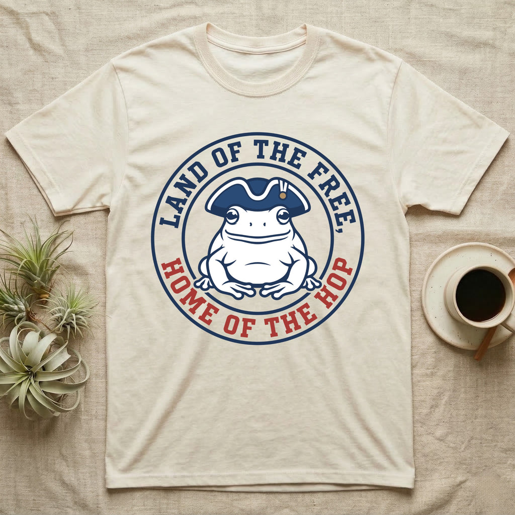 American Toad Emblem T-Shirt in Natural — Round emblem of a white American toad silhouette in a tricorn hat with text Land of the Free, Home of the Hop.