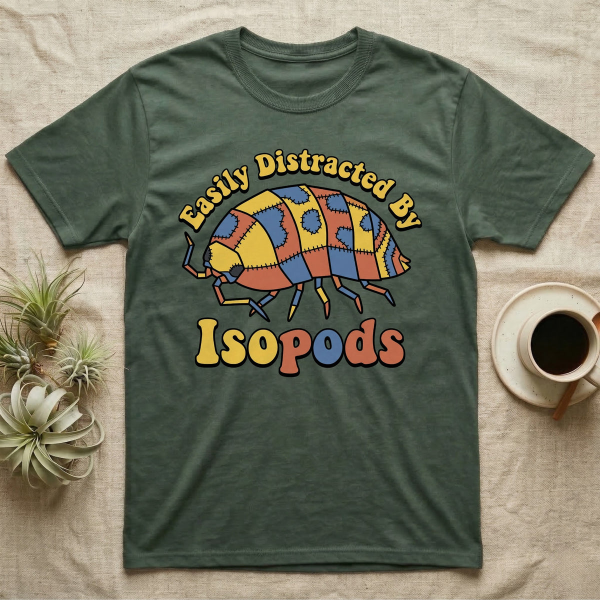Dairy Cow Isopod Patchwork T-Shirt in Military Green — Quilt-patchwork dairy cow isopod in mustard and denim under retro "Easily Distracted By Isopods" text.