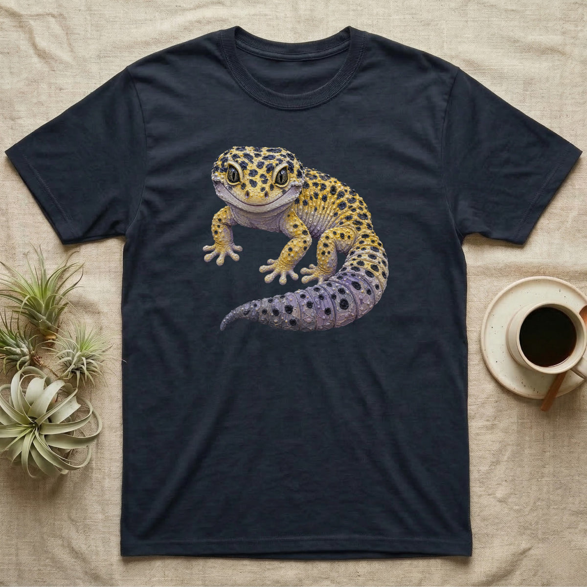 Dark t-shirt featuring a colorful illustration of a leopard gecko.
