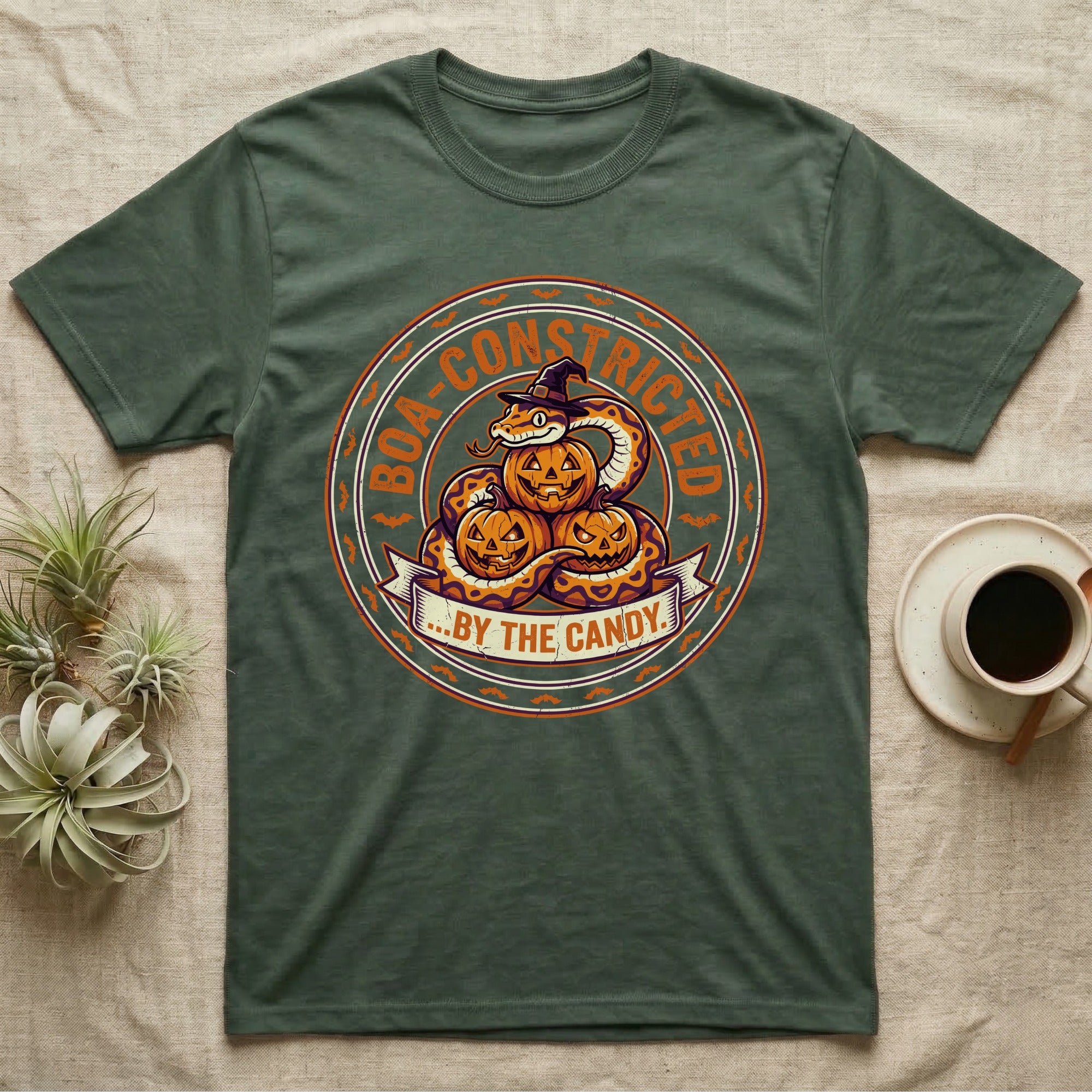 Ball Python Boa-Constricted Candy T-Shirt in Military Green — Distressed badge of a witch-hatted ball python on three jack-o'-lanterns, "Boa-Constricted by the Candy."