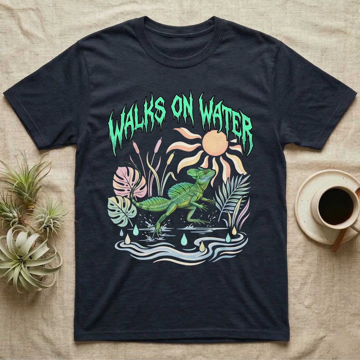 Green Basilisk Feral T-Shirt in Navy — Green plumed basilisk sprinting across water below a dripping aqua-green metal "Walks On Water" wordmark