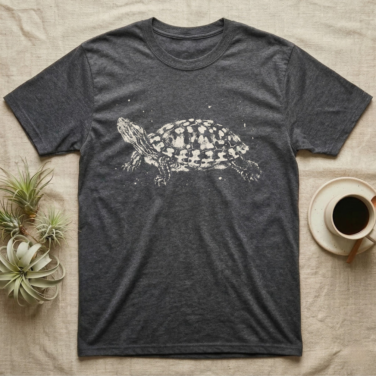 Red-Eared Slider Bleach T-Shirt in Dark Heather — Red-eared slider in side view basking with its neck stretched out, made of pale bleach spatter on black