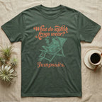 Poison Dart Frog Jumpsuit T-Shirt in Military Green — Illustrated green and black poison dart frog reclining in a beach chair with sunglasses and a cocktail, coral script asking what stylish frogs wear, answer jumpsuits.