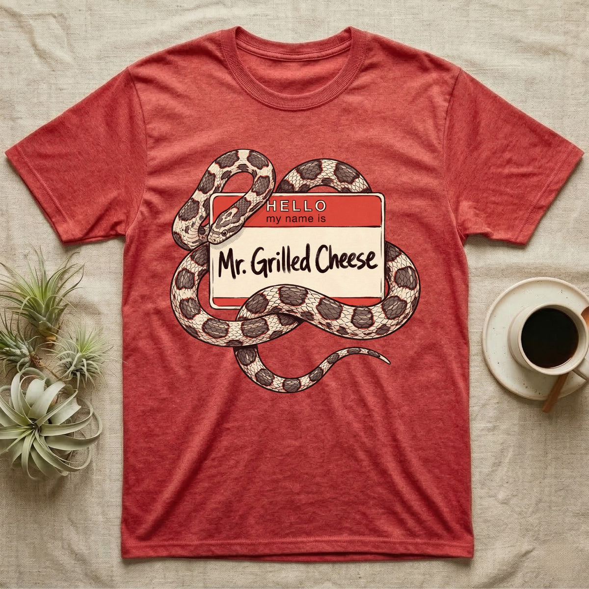 Grilled Cheese Corn Snake T-Shirt in Heather Red — Flat retro illustration of a corn snake coiled through a "Hello my name is Mr. Grilled Cheese" name-tag badge.