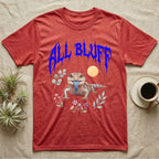 Northern Blue-Tongue Skink Feral T-Shirt in Heather Red — Blue-tongue skink with its blue tongue out under a jagged cobalt-blue metal "ALL BLUFF" wordmark and pastel leaves.