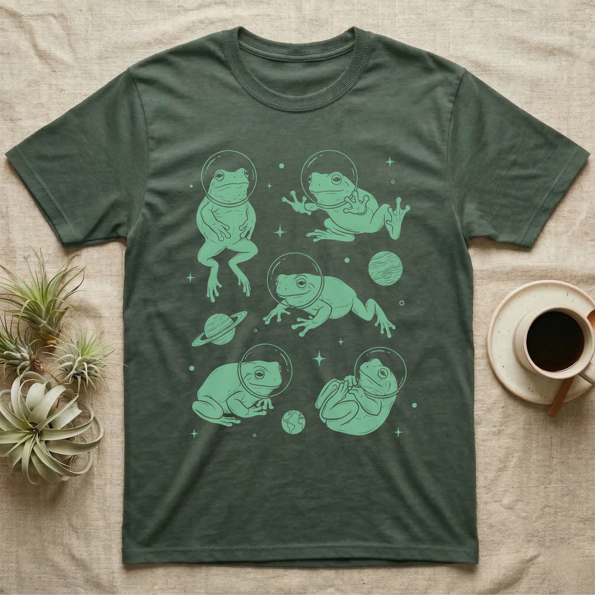 Whites Tree Frog Cosmic T-Shirt in Military Green — Vintage screen-print illustration of White's tree frogs in astronaut helmets floating in space, cosmic jade green monochromatic on dark background.