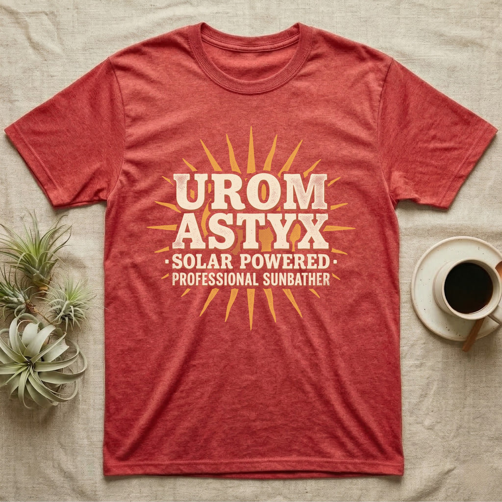 Solar Powered Uromastyx T-Shirt in Heather Red — Desert-poster wordmark reading "Uromastyx Solar Powered Professional Sunbather" with a small radiating sun motif.