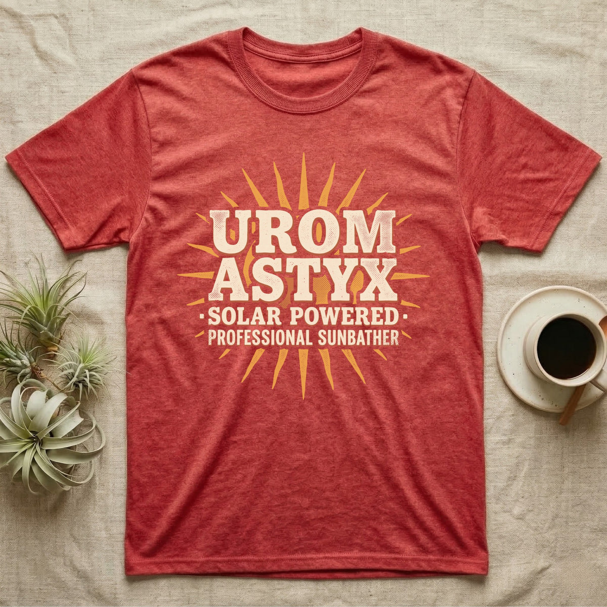 Solar Powered Uromastyx T-Shirt in Heather Red — Desert-poster wordmark reading "Uromastyx Solar Powered Professional Sunbather" with a small radiating sun motif.
