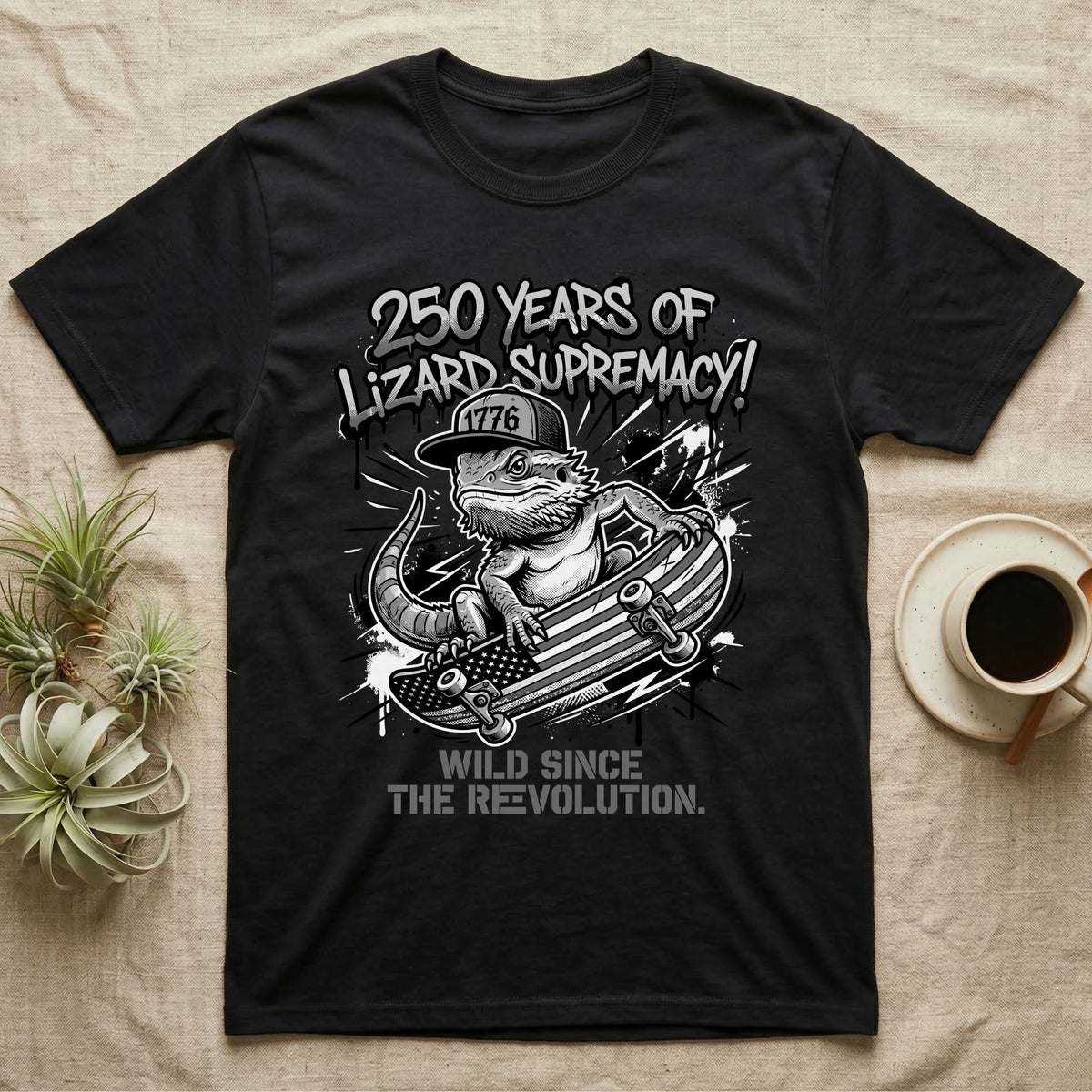 Bearded Dragon Skater T-Shirt in Black — Black-and-white bearded dragon in a 1776 snapback on a flag skateboard under text 250 Years of Lizard Supremacy.