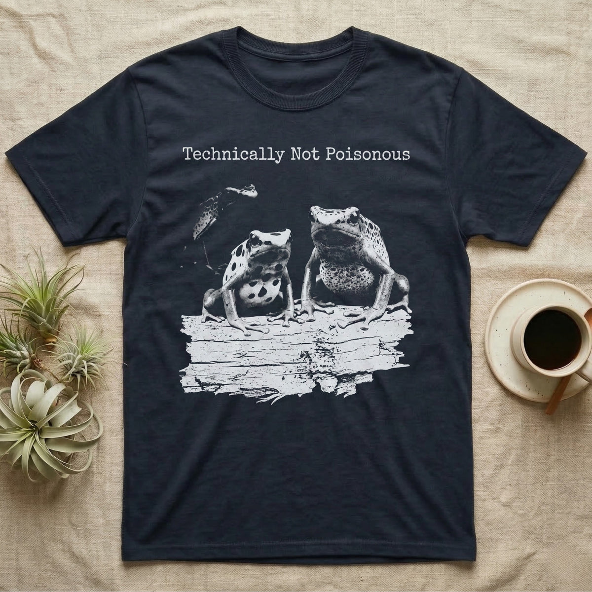 Technically Not Poisonous Dart Frog T-Shirt in Navy — Three blue poison dart frogs on a bark ledge in distressed screen-print style under the line Technically Not Poisonous.