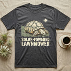 Solar Powered Lawnmower T-Shirt in Dark Heather — Retro-illustration of a sulcata tortoise grazing a lawn stripe under a sun motif with a Solar-Powered Lawnmower caption.