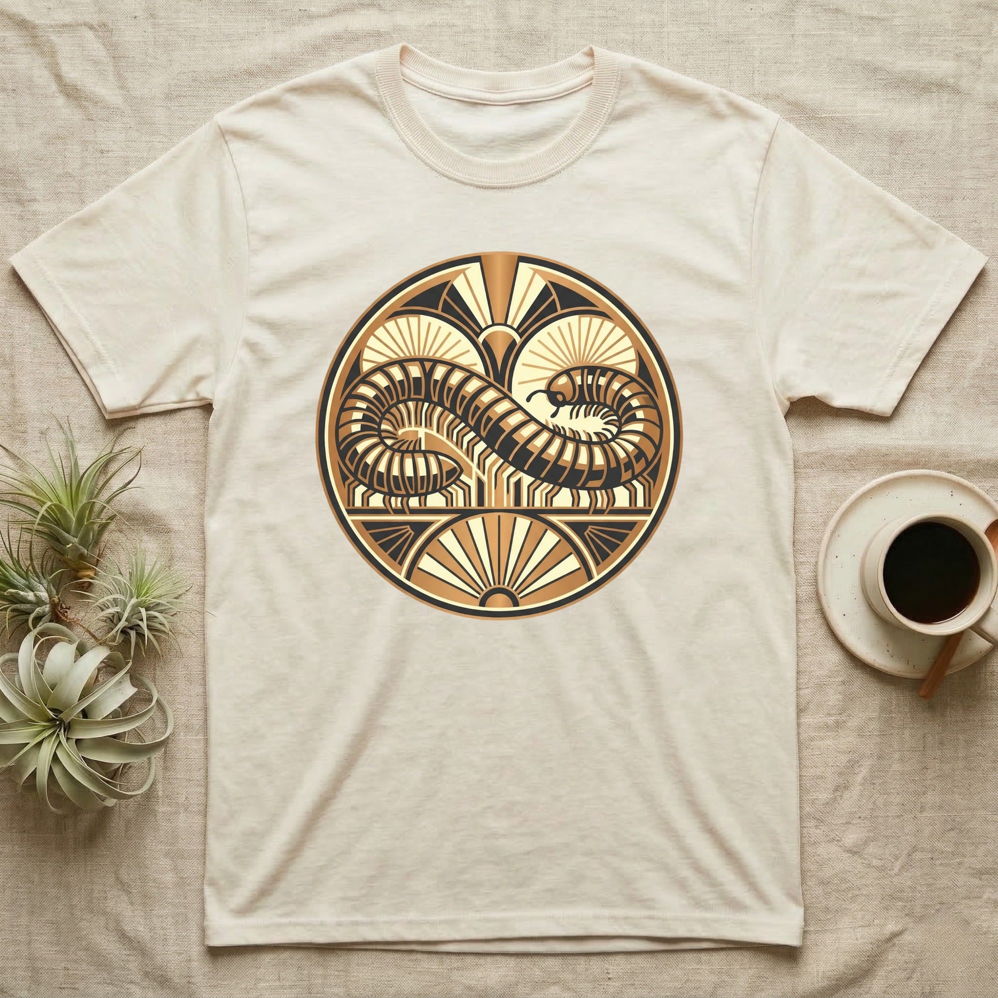 Cream t-shirt with circular art deco design of a coiled serpent or dragon.