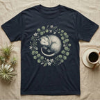 Navy t-shirt with sleeping possum and floral wreath design.