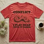 Hognose Conflict T-Shirt in Heather Red — Engraved western hognose snake twisted over and playing dead with its tongue out, between the words CONFLICT and I PLAY DEAD UNTIL IT PASSES.