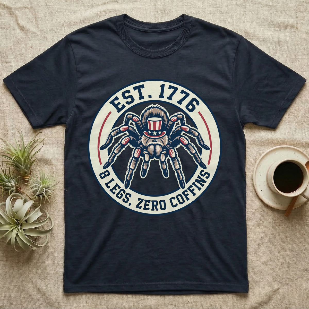 Tarantula Zero Coffins T-Shirt in Navy — Circular patch emblem of a tarantula in a top hat with arched text Est. 1776 and 8 Legs Zero Coffins.