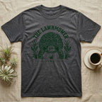 Sulcata Tortoise Under Lawn T-Shirt in Dark Heather — Engraved sulcata tortoise in white line, head down and legs braced mid-dig, under retro script reading UNDER THE LAWN.