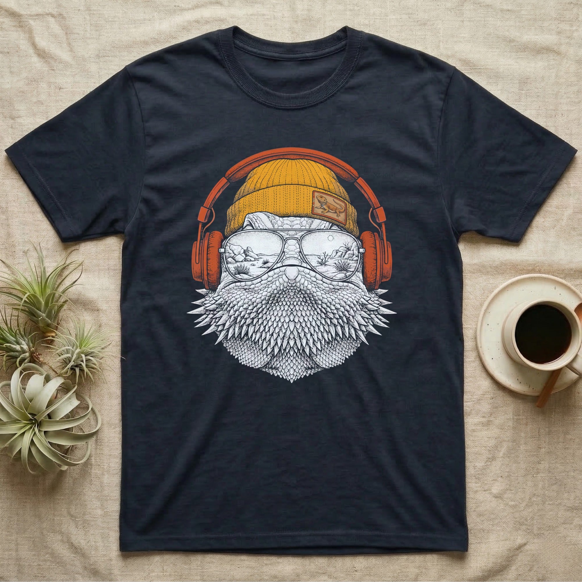 Bearded Dragon Headphones T-Shirt in Navy — Engraved bearded dragon with spiked beard in a beanie and headphones, aviators reflecting a desert canyon.