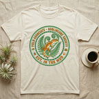 Cream t-shirt with green and orange "Goblincore Society" emblem featuring a gecko and ferns.