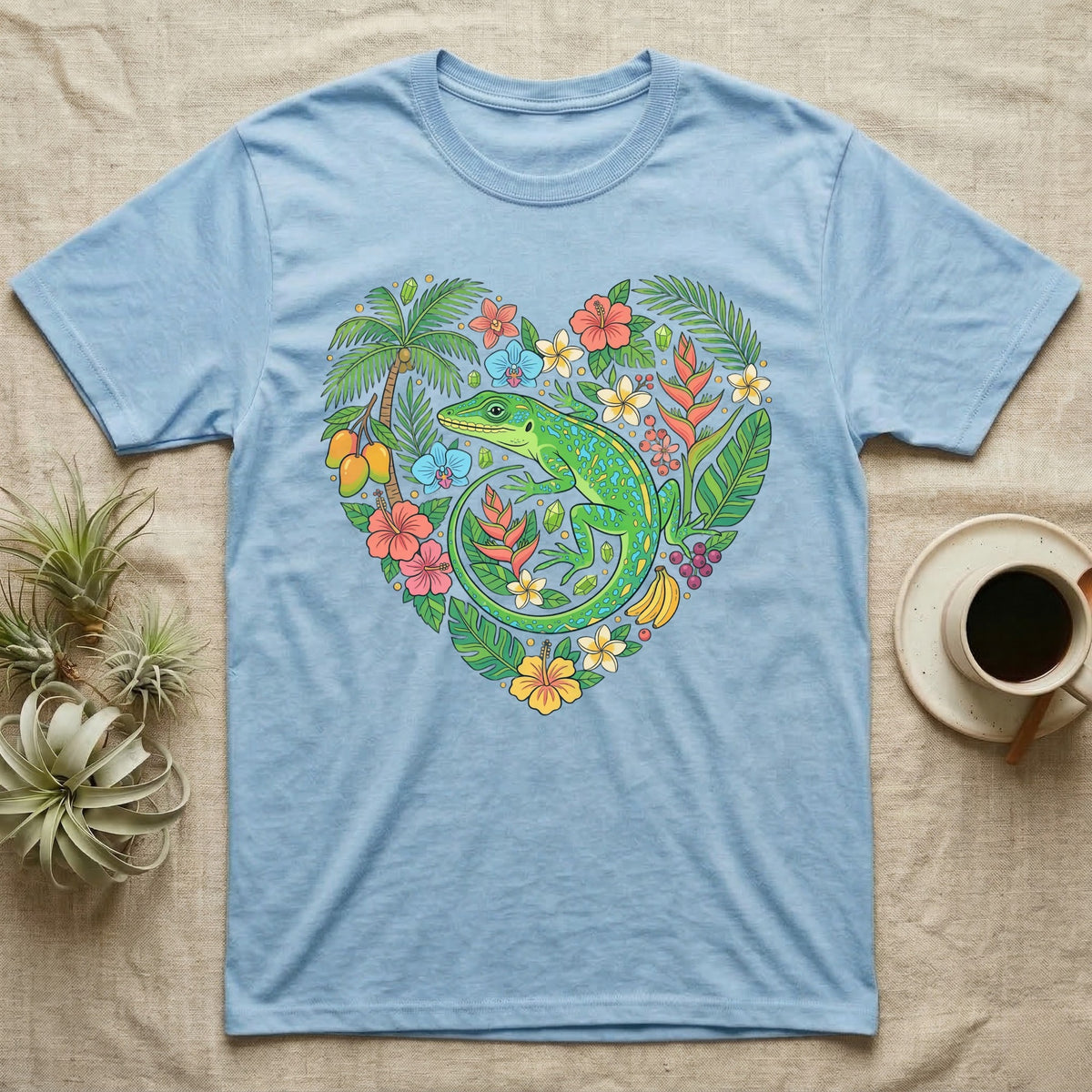 Light blue t-shirt with a heart-shaped tropical design featuring a green lizard.