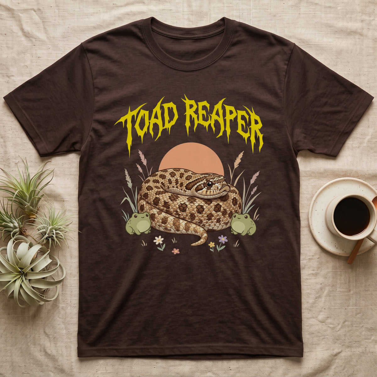 Hognose Toad Reaper T-Shirt in Dark Chocolate — Realistic western hognose coiled in a loaf between two cartoon toads under jagged yellow lettering: TOAD REAPER