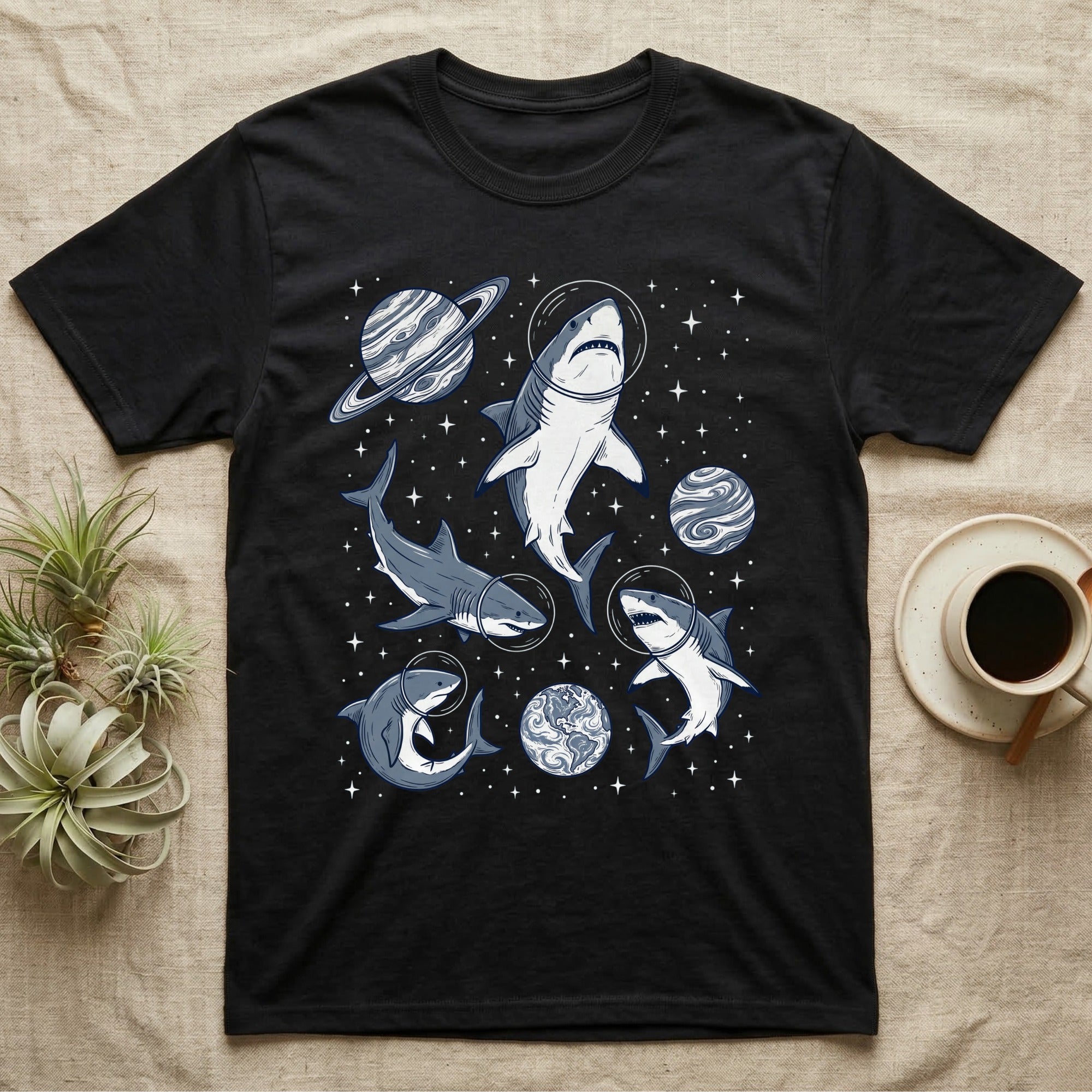 Black t-shirt with cartoon sharks in space suits, planets, and stars.