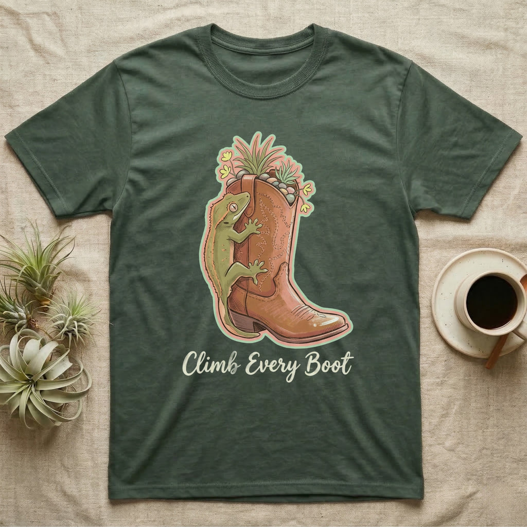 Green t-shirt with brown cowboy boot and gecko illustration and text "Climb Every Boot".