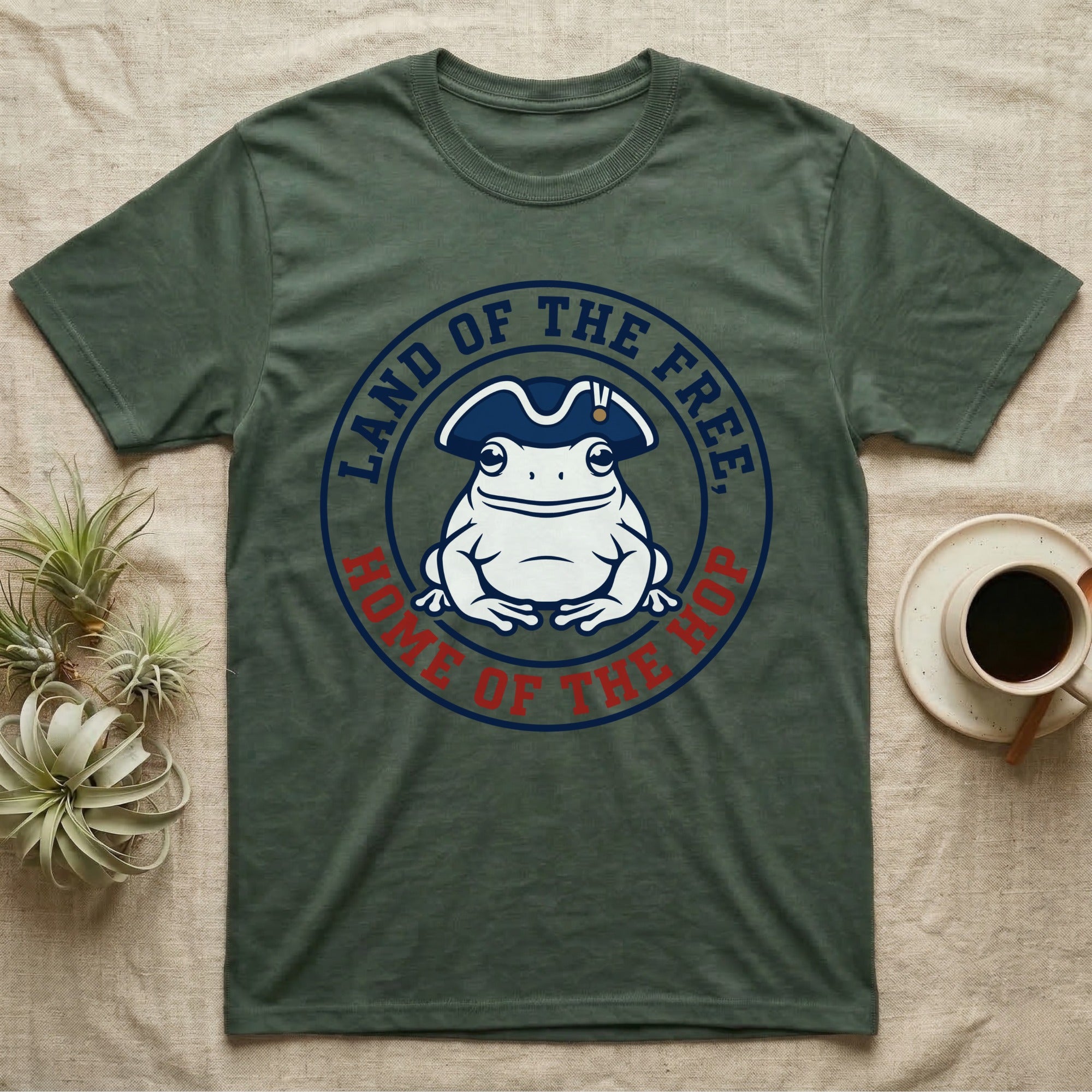 American Toad Emblem T-Shirt in Military Green — Round emblem of a white American toad silhouette in a tricorn hat with text Land of the Free, Home of the Hop.