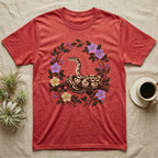 Ball Python Opinions Television T-Shirt in Heather Red — Oil-painted ball python coiled on a branch, enclosed by a dense oval bower of flowering bramble.