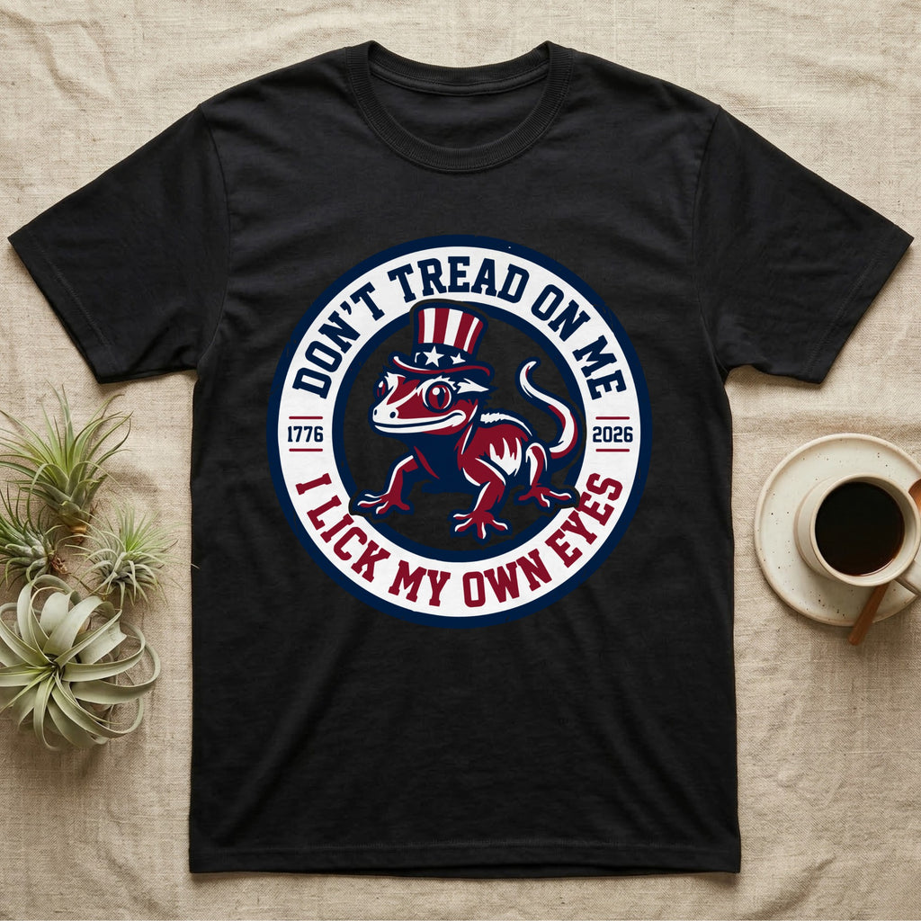 Crested Gecko 1776 T-Shirt in Black — Distressed crest of a crested gecko in a top hat with text Don't Tread On Me and I Lick My Own Eyes.