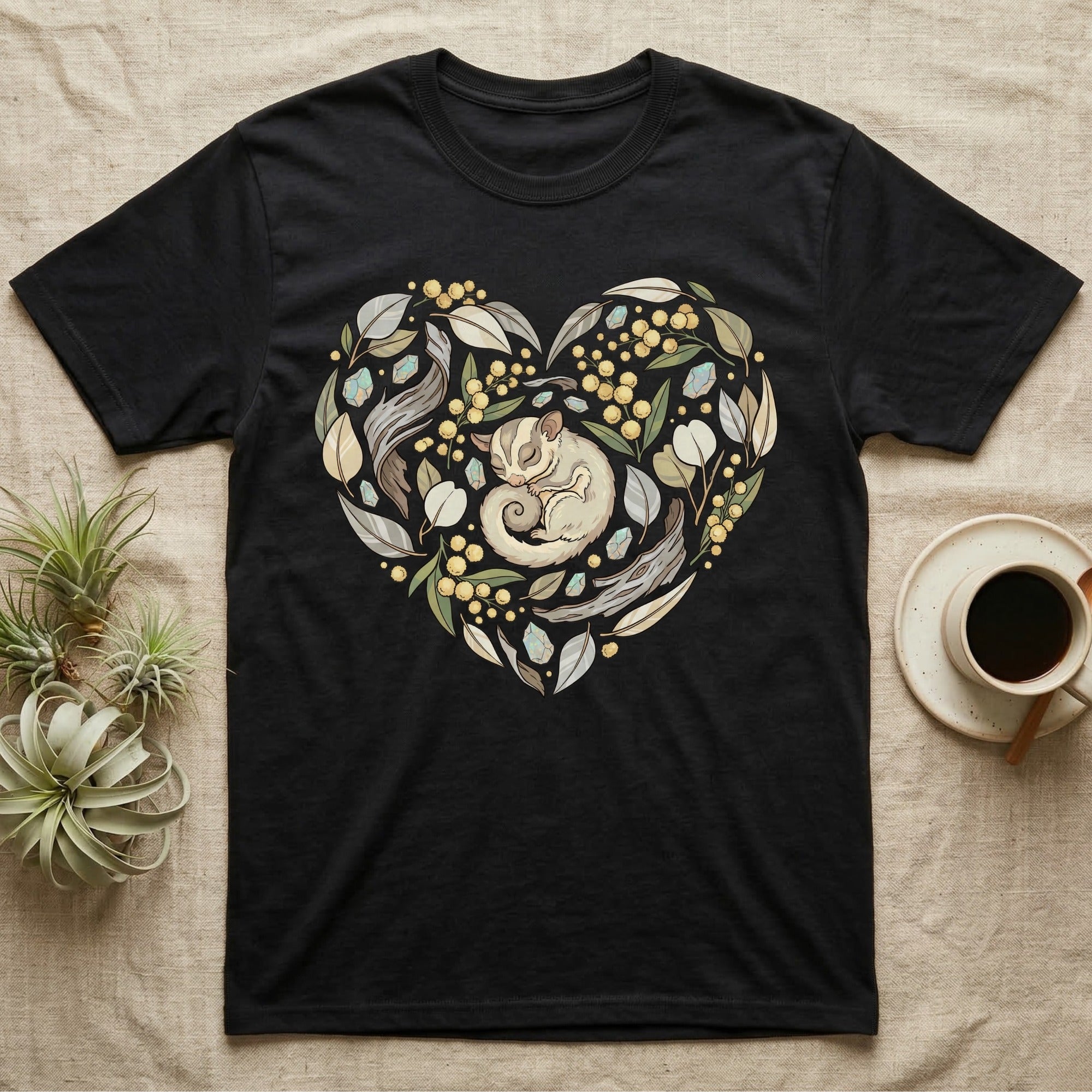 Black t-shirt with heart-shaped floral and leaf design featuring a sugar glider.
