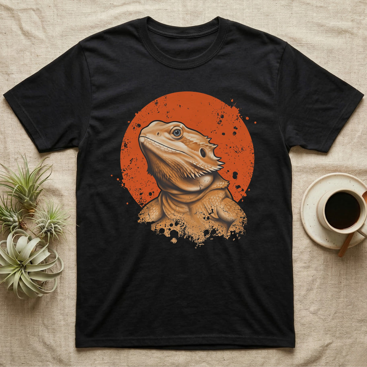 Bearded Dragon Orange Disc T-Shirt in Black — Bearded dragon bust in warm ochre breaking out of the lower edge of a flat distressed orange disc on grey