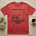 Sulcata Fridge Standoff T-Shirt in Heather Red — Engraved sulcata tortoise waiting in front of a closed fridge between the words the salad comes to me and I OUTWAIT YOU.