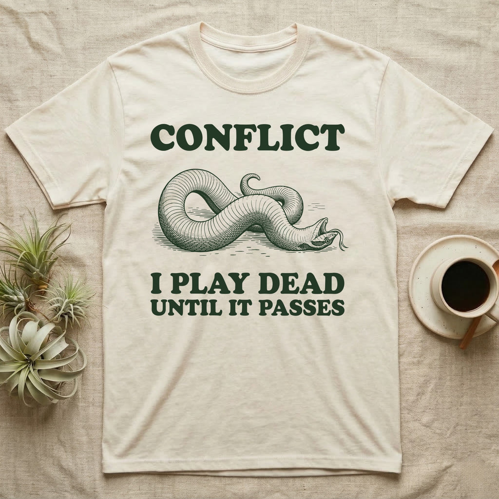 Hognose Conflict T-Shirt in Natural — Engraved western hognose snake twisted over and playing dead with its tongue out, between the words CONFLICT and I PLAY DEAD UNTIL IT PASSES.