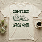 Hognose Conflict T-Shirt in Natural — Engraved western hognose snake twisted over and playing dead with its tongue out, between the words CONFLICT and I PLAY DEAD UNTIL IT PASSES.