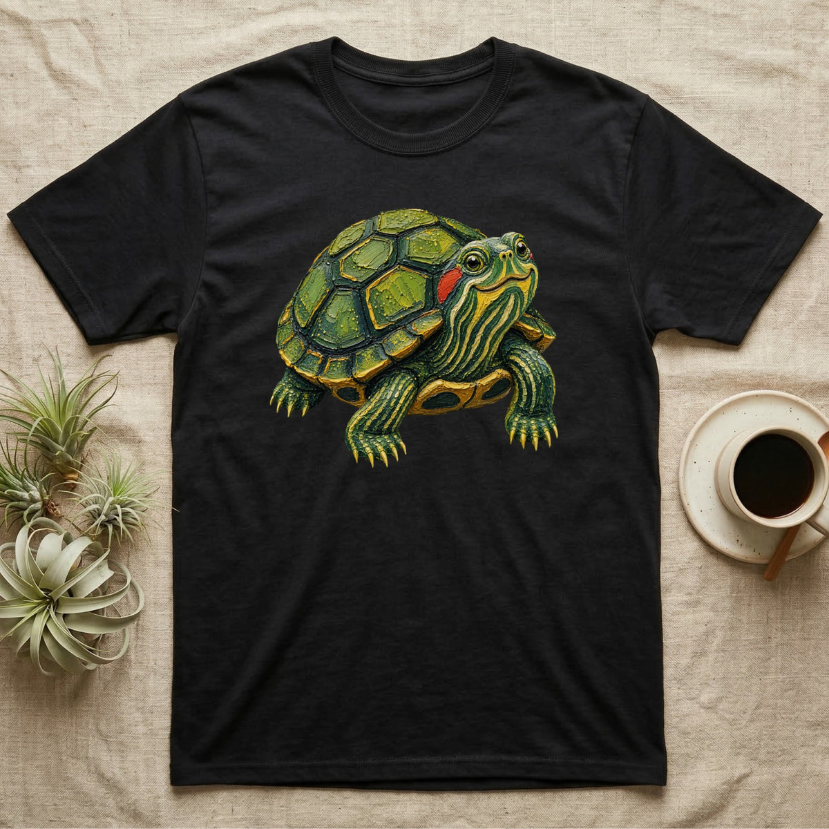 Black t-shirt with a detailed graphic of a green turtle with red markings.