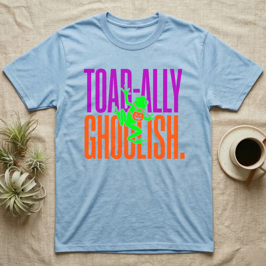 Tree Frog Toad-ally Ghoulish T-Shirt in Light Blue — Neon green tree frog with a pumpkin pail clinging across stacked text, "Toad-ally Ghoulish."
