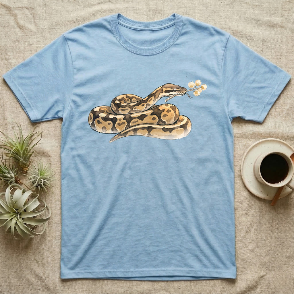 Ball Python Blossom T-Shirt in Light Blue — Watercolor illustration of a tan-and-brown ball python holding an acacia blossom sprig, on a dark grey t-shirt.