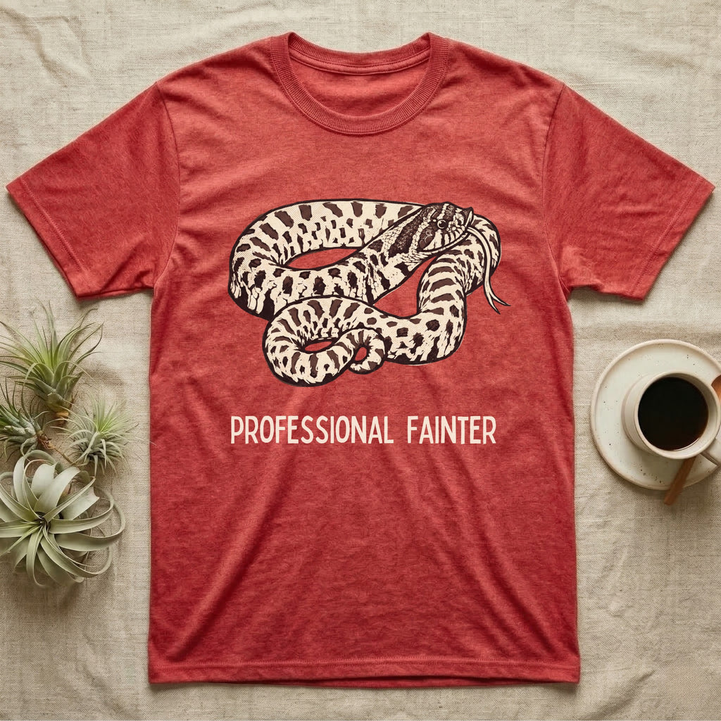 Hognose Professional Fainter T-Shirt in Heather Red — Linocut block-print of a western hognose snake flopped belly-up in a death-feign with professional fainter caption.