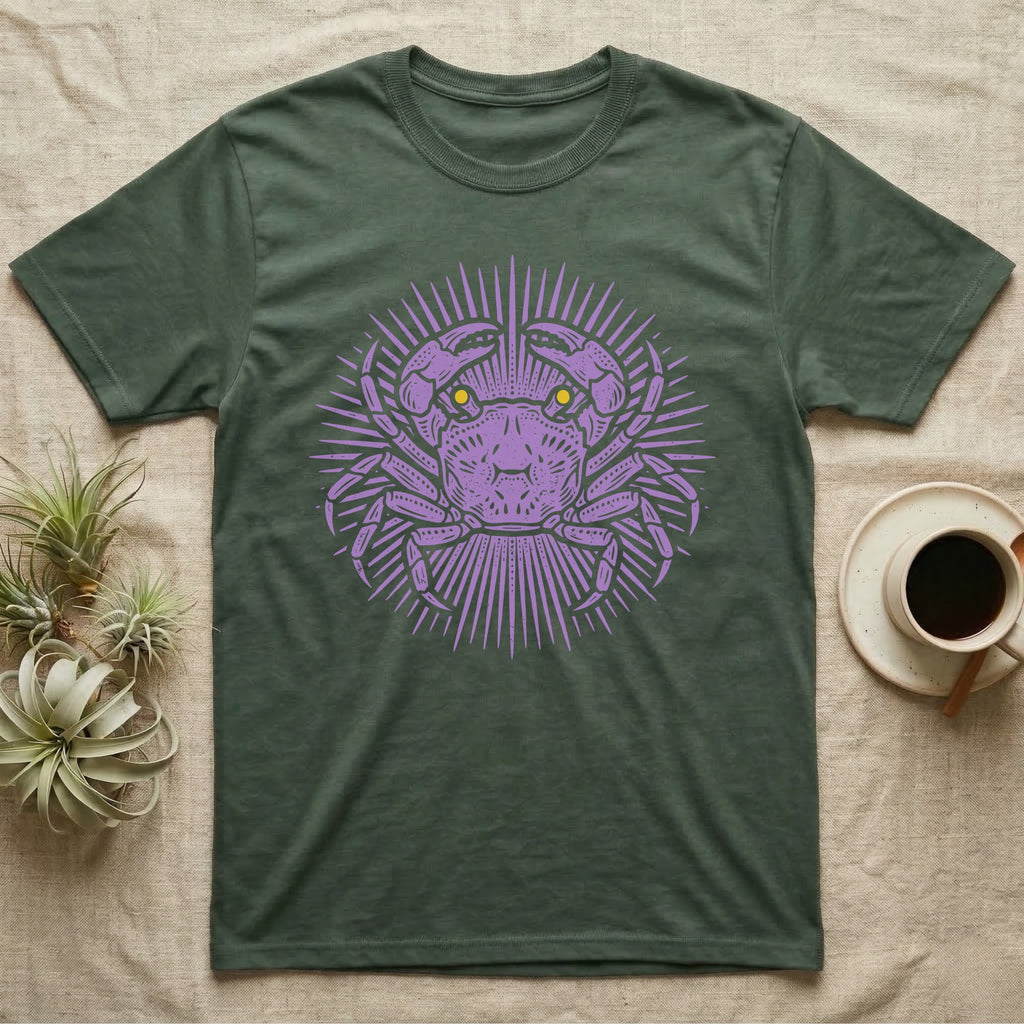 Vampire Crab Folk Medallion T-Shirt in Military Green — Violet woodblock vampire crab seen face-on, its raised claws cut into a contained folk sunburst medallion.