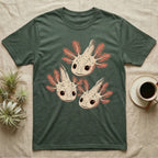 Vintage comic screen-print illustration of three axolotls clustered together with coral feathery gills and sparkling star-highlighted eyes, graphic-only, no text. — shown on a Military Green tee.