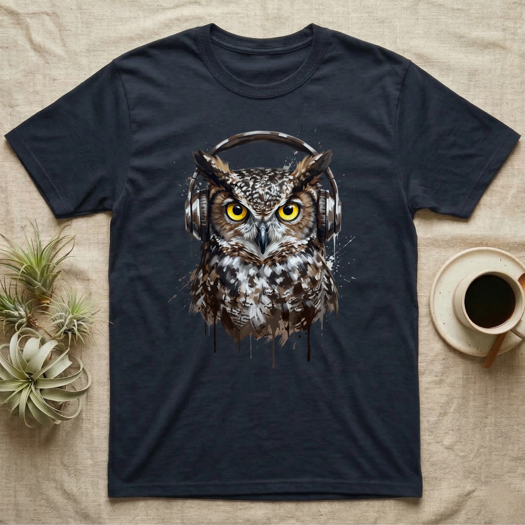 Dark t-shirt with graphic of an owl wearing headphones, coffee cup and plants nearby.