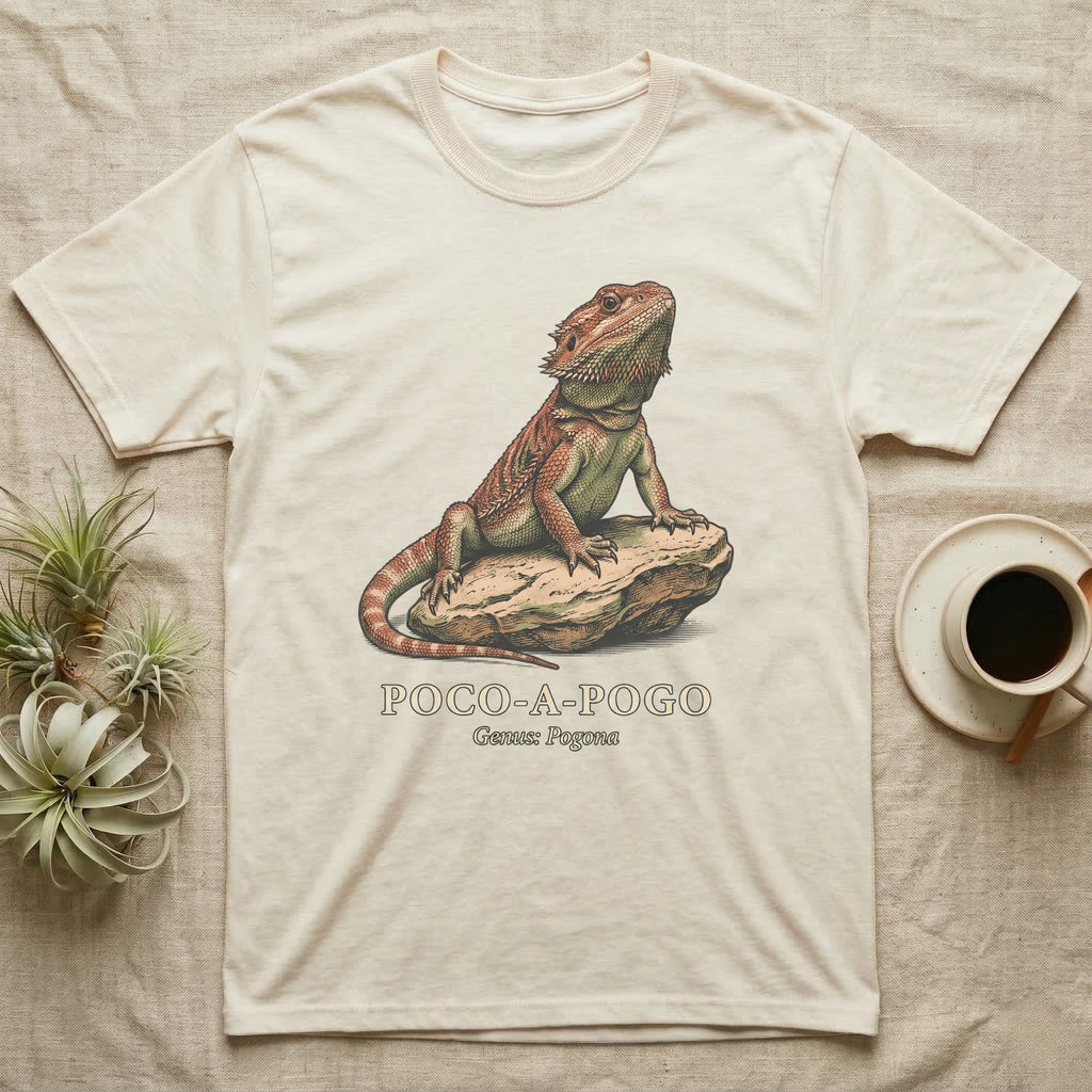 Beige t-shirt with illustration of a bearded dragon on a rock.